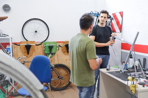 People is a workshop assembling a 3D printed bicycle